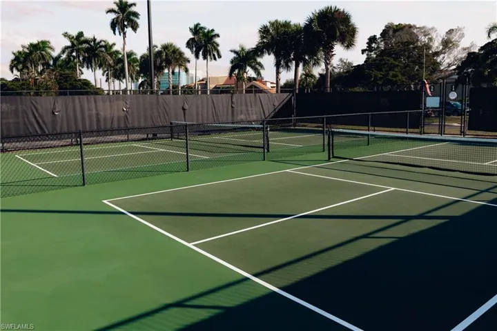 View of tennis court featuring community basketball court