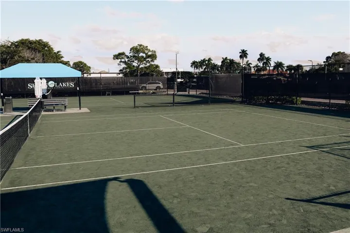 View of tennis court with community basketball court