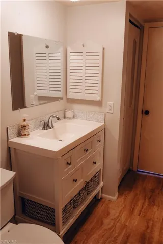 Half bath with vanity and light wood-style flooring