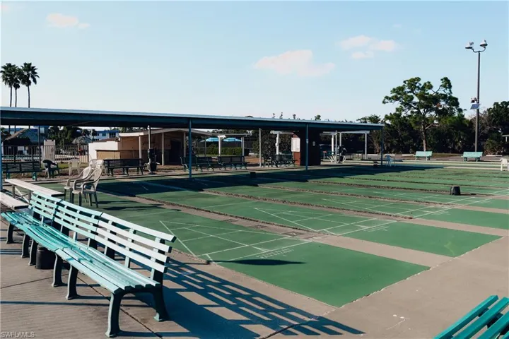 View of property's community featuring shuffleboard