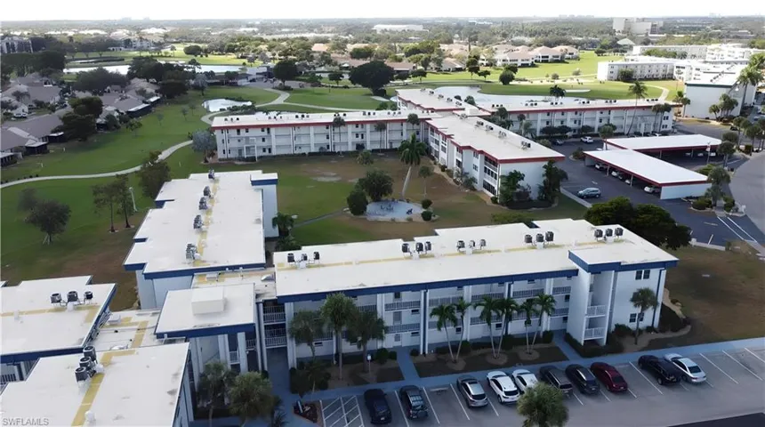 Aerial view of apartment complex / building and a golf club