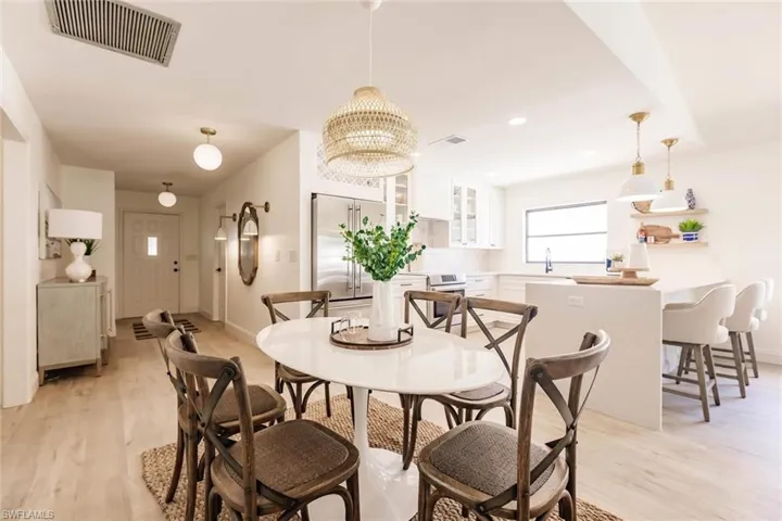 Dining space featuring a chandelier, light wood finished floors, and recessed lighting