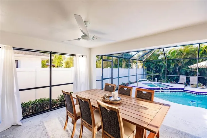 Dining area featuring a sunroom, ceiling fan, unfinished concrete floors, and plenty of natural light