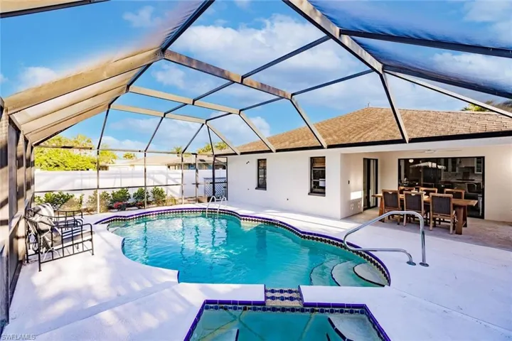 View of pool with a sunroom, a patio area, a pool with connected hot tub, and a lanai