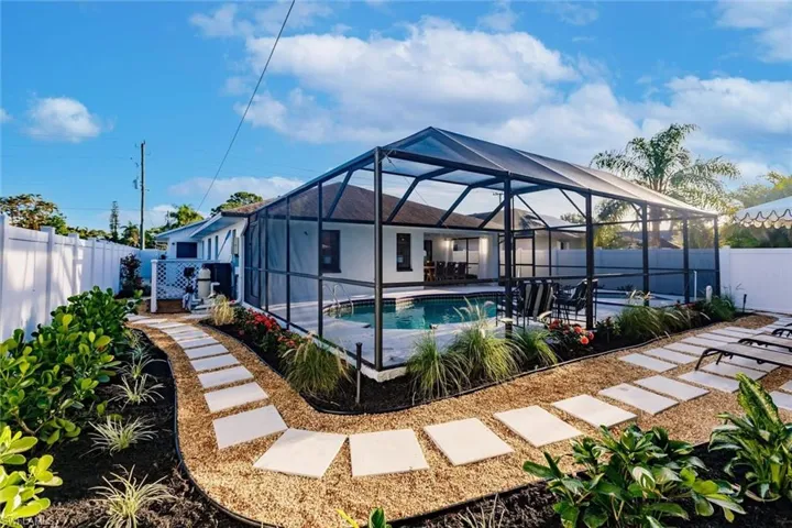 View of pool with a fenced backyard, glass enclosure, a patio area, and a sunroom