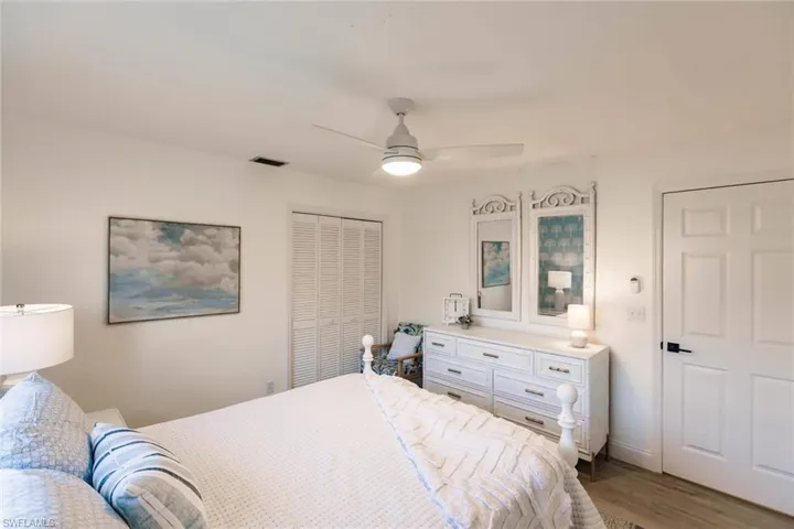 Bedroom featuring a closet, ceiling fan, and dark wood-type flooring