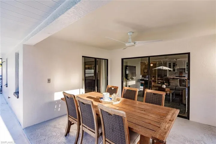 Dining area with a textured wall and ceiling fan