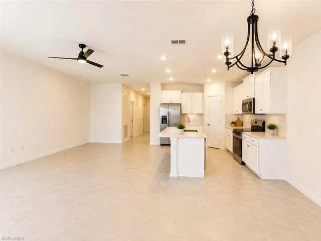 Open-concept living space with light-toned tile flooring throughout