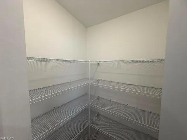 Walk-in pantry featuring white wire shelving