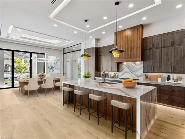 Virtually staged kitchen and dining area.