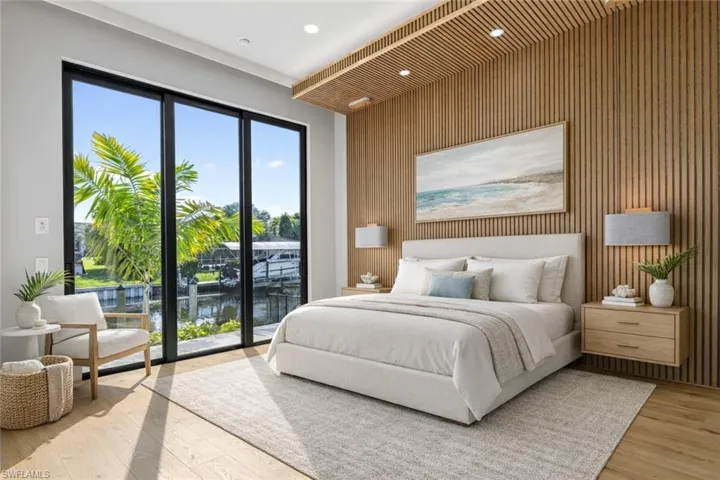 Virtually staged bedroom suite number 2 has sliding glass door to the dock and a side door to the pool area.