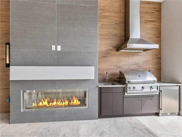 Outdoor summer kitchen with fireplace.