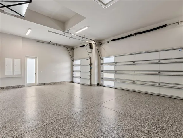 3 car garage with epoxy floors and 12.5 ft ceilings for your car lifts!