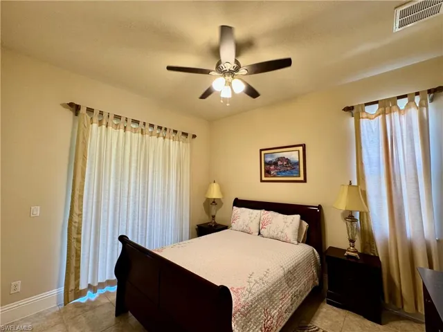 Bedroom featuring light tile patterned floors and ceiling fan