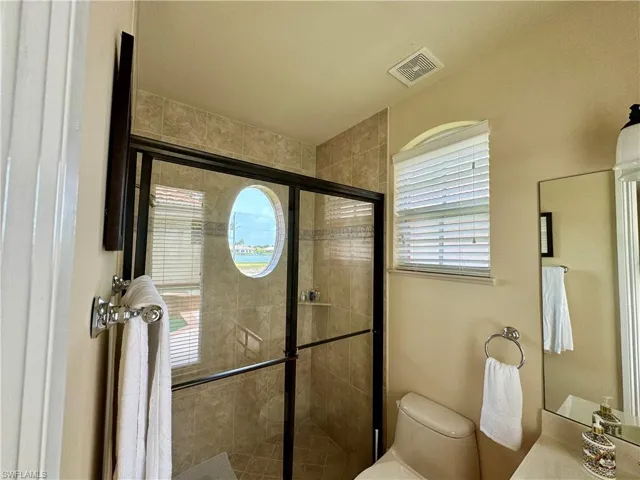 Bathroom featuring a stall shower, plenty of natural light, and vanity