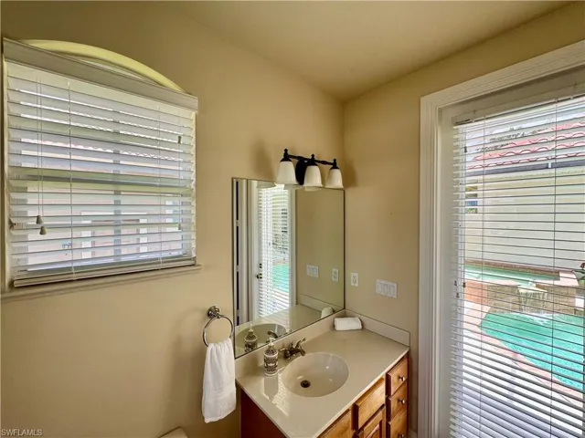 Half bathroom featuring vanity and toilet
