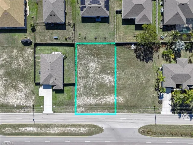 Aerial perspective of suburban area featuring property parcel outlined
