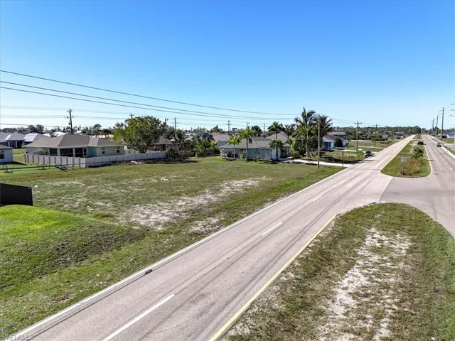 View of asphalt road featuring a residential view