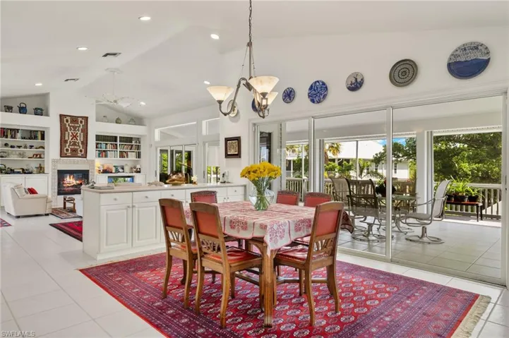 Dining space with built in features, high vaulted ceiling, light tile patterned floors, and plenty of natural light