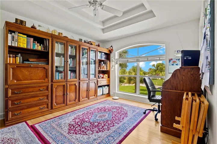 Office space with ceiling fan and light wood-type flooring