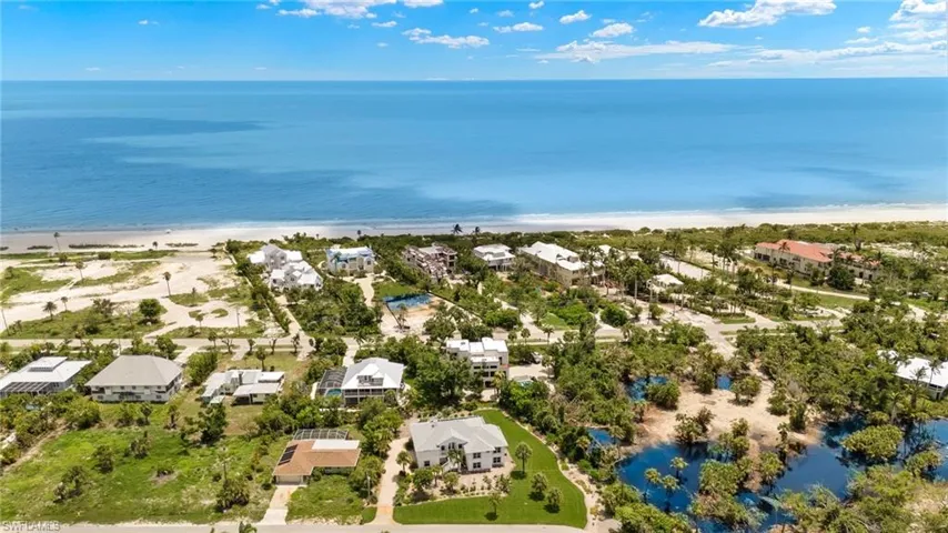 Aerial view featuring a view of the beach and a water view