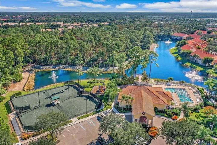 Aerial of tennis courts, club house, pool, fishing pier and preserve.