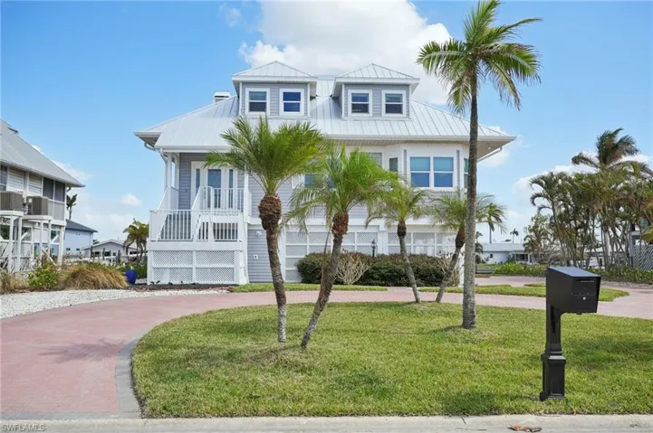 View of front facade featuring covered porch and a front yard
