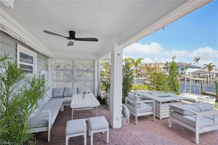 View of patio featuring an outdoor living space, a water view, and ceiling fan
