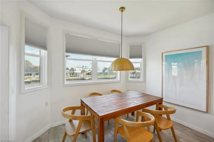Dining space with hardwood / wood-style floors