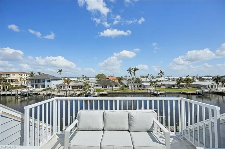 Balcony featuring a deck with water view