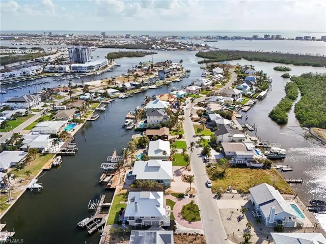 Birds eye view of property with a water view