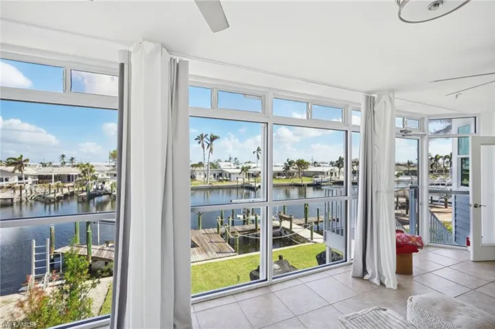 Entryway with a water view and light tile patterned floors