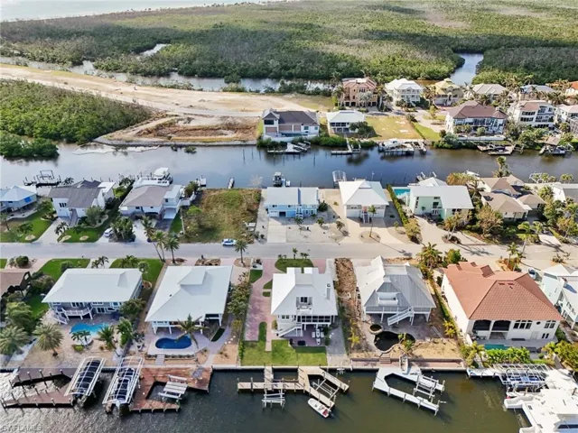 Birds eye view of property with a water view