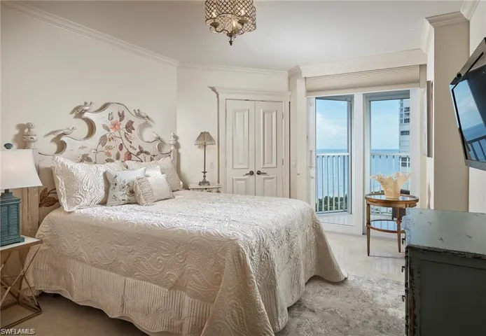 Bedroom featuring ornamental molding and access to exterior