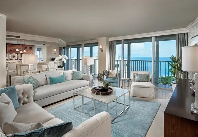 Living room featuring a water view and crown molding