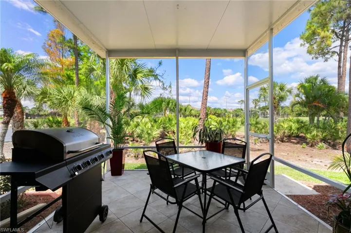 Sunroom / solarium with outdoor dining space, floor to ceiling windows, and tile patterned flooring