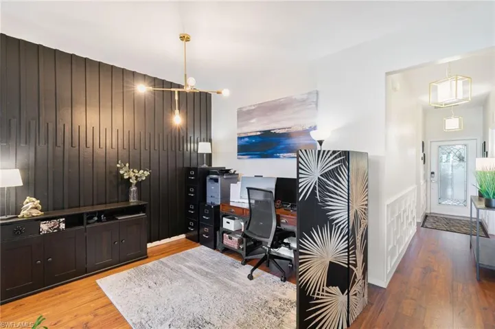 Office with an inviting chandelier and wood finished floors