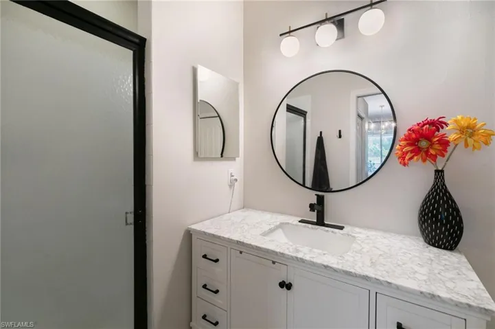 Bathroom featuring a stall shower and vanity