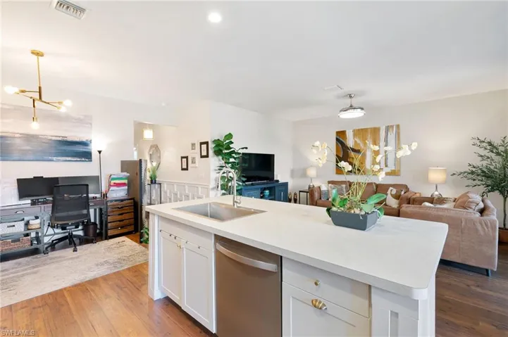 Kitchen featuring a chandelier, open floor plan, visible vents, stainless steel dishwasher, and a sink