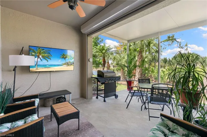 View of patio with grilling area, outdoor dining space, an outdoor living space, and a ceiling fan