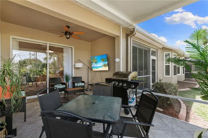 View of patio / terrace with grilling area, a ceiling fan, and outdoor dining area