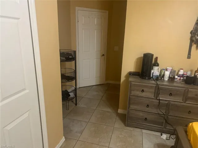 Bedroom featuring baseboards and light tile patterned flooring