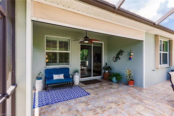 BEAUTIFUL LARGE TILES ON THE LANAI WITH MEDALLIONS! IMPORTANT: NOTE THE ACCORDION STORM SHUTTERS ON ALL WINDOWS PROTECTING YOUR FUTURE HOME=PEACE OF MIND!