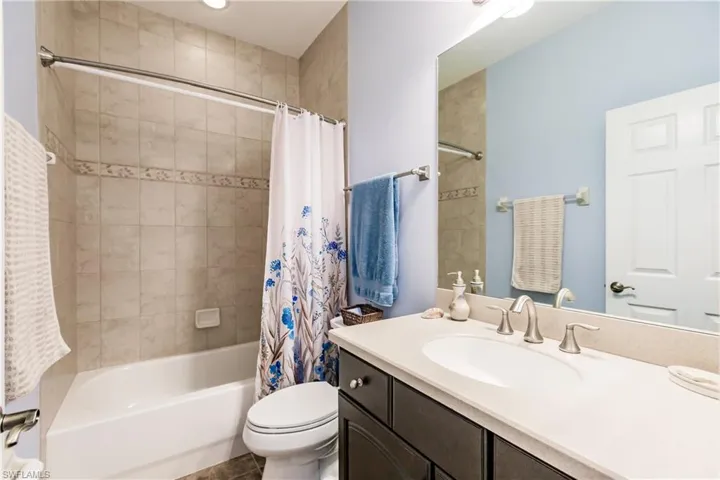 GUEST BATHROOM HAS A SHOWER/SOAKING TUB & IS BEAUTIFULLY TILED TO THE TOP!