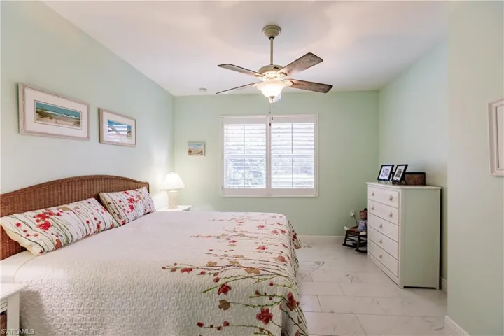 FLORIDIAN SCHEME PAINTED MASTER WITH PLANTATION SHUTTERS & UPDATED FAN W/LIGHTING IS BRIGHT & CHARMING WITH A CLASSY LOOK!