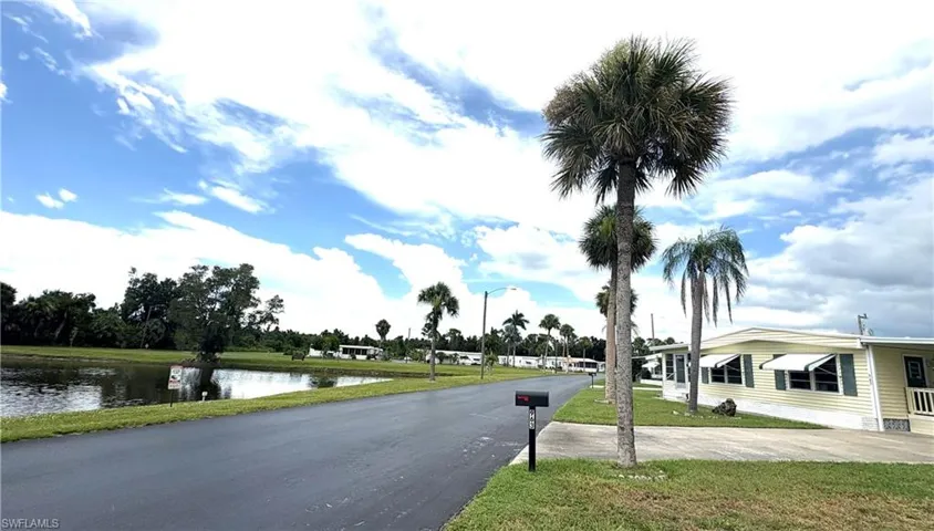 Front of the home with view of the pond. The owner has a quarterly pest control program in place.