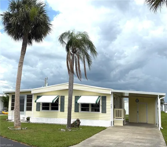 Lovely curb appeal right across the lake. This home has a brand NEW ROOF & CARPORT!