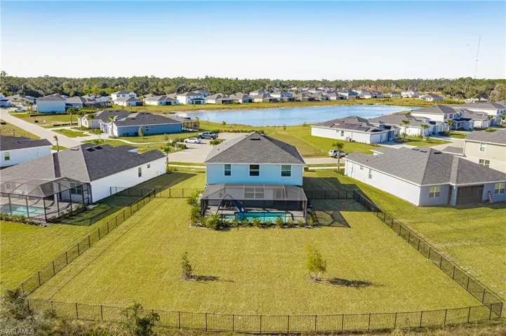 Aerial view of residential area featuring a nearby body of water