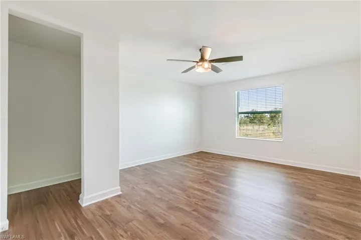 Unfurnished room featuring light wood-style floors and a ceiling fan