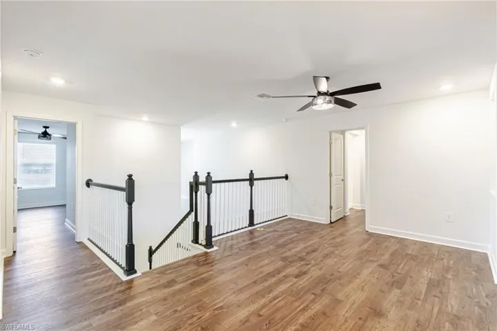 Empty room with a ceiling fan, recessed lighting, and wood finished floors